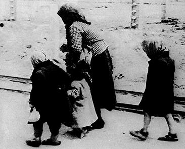 Víctimas de la guerra.Anciana caminando con niños.
